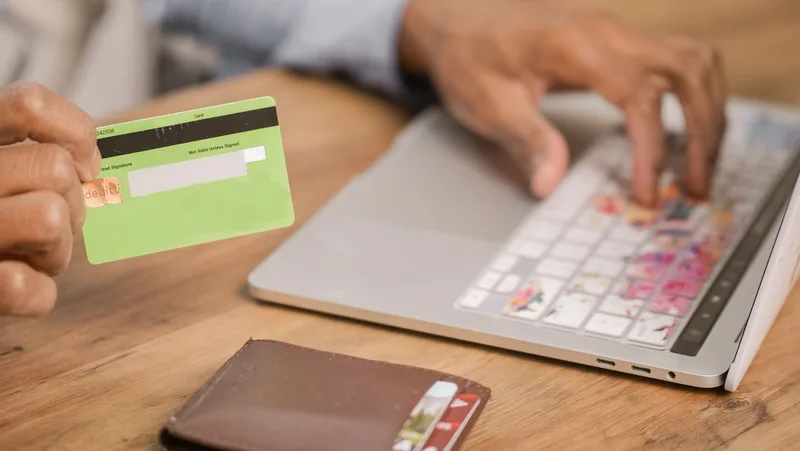 Person completing an online purchase on a laptop