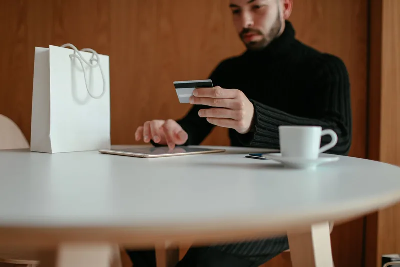 Two shoppers comparing payment options on a tablet