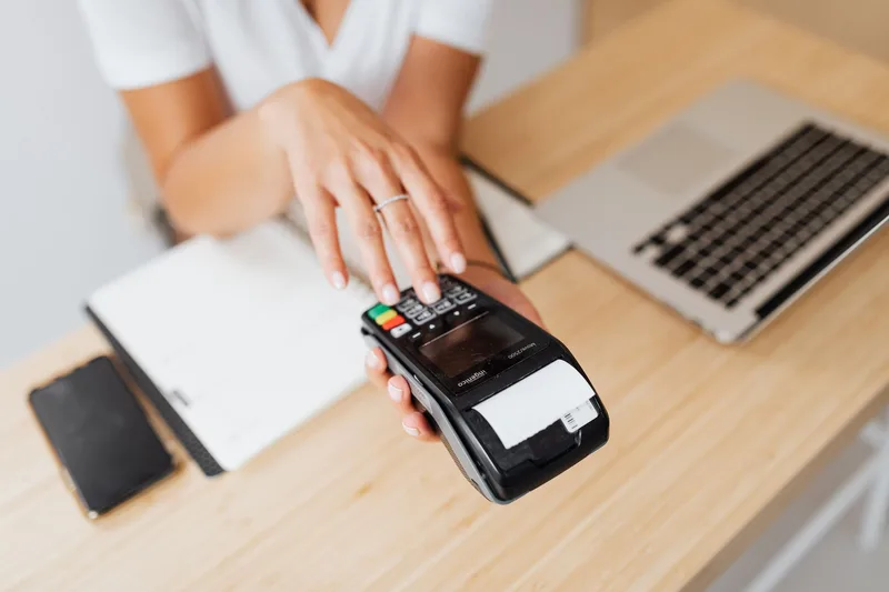 Payment terminal processing a transaction at a merchant counter